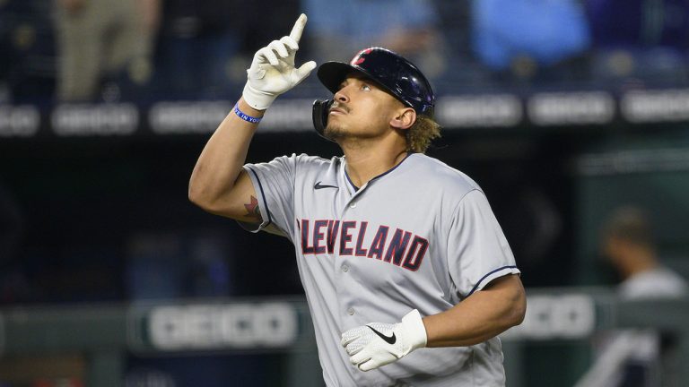 Cleveland left fielder Josh Naylor (22) points skyward as he jogs to home plate after hitting a two-run home run during the seventh inning of a baseball game against the Kansas City Royals. (Reed Hoffmann/AP)