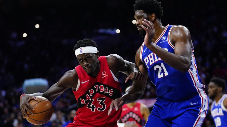 Toronto Raptors' Pascal Siakam, left, tries to get past Philadelphia 76ers' Joel Embiid during the first half of an NBA basketball game. (Matt Slocum/AP)