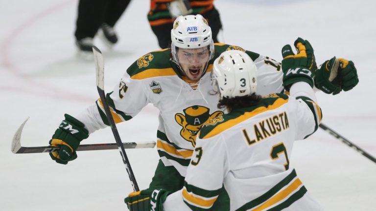 Alberta Golden Bears' Noah Philp, left, celebrates his goal with teammate Joel Lakusta during the University Cup gold medal game against Universite du Quebec a Trois-Rivieres Patriotes, in Wolfville, N.S., Sunday, April 3, 2022. (Tim Krochak/THE CANADIAN PRESS)