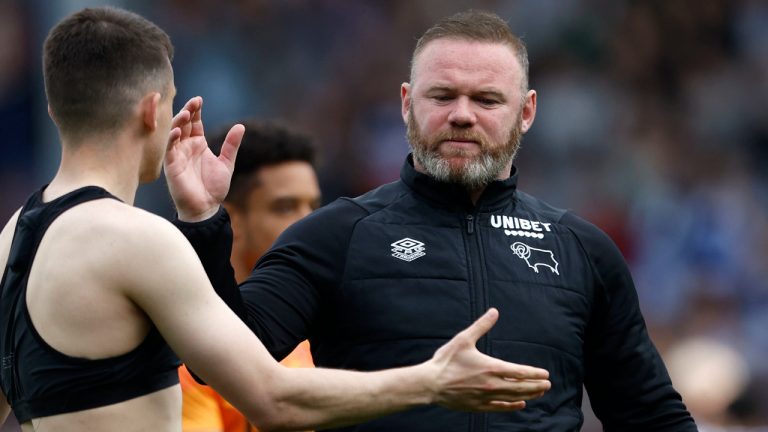 Derby County manager Wayne Rooney reacts at the Kiyan Prince Foundation Stadium, London, Monday April 18, 2022. Wayne Rooney's Derby County has been relegated to the third tier of English soccer to cap a miserable season that also saw the club docked 21 points for breaches of financial rules. A 1-0 loss at Queens Park Rangers left Derby 10 points from safety with three games remaining in the second-tier Championship. (Steven Paston/PA via AP)