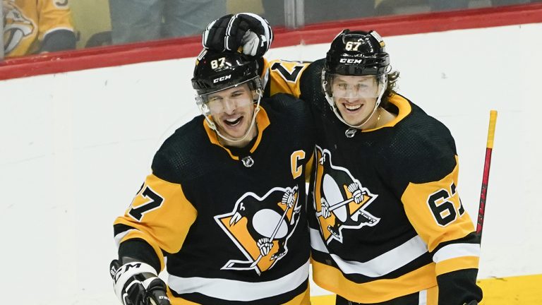 Pittsburgh Penguins' Sidney Crosby, left, celebrates with Rickard Rakell (67) after scoring the game winning goal against the Nashville Predators during the overtime period of an NHL hockey game. (Keith Srakocic/AP)