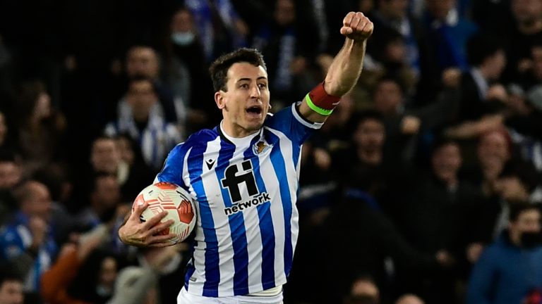 Real Sociedad's Mikel Oyarzabal celebrates after his teammate Real Sociedad's Martin Zubimendi scores his side's opening goal during the Europa League Play-off, second leg, soccer match between Real Sociedad and Leipzig at the Reale Arena stadium in San Sebastian, Spain, Thursday, Feb. 24, 2022. (Alvaro Barrientos/AP)