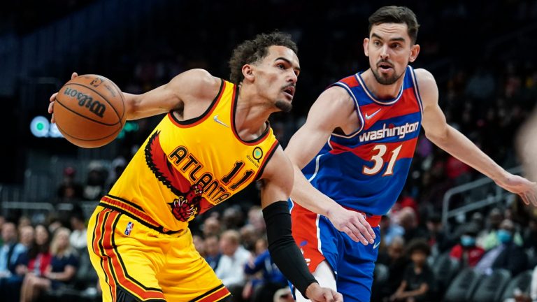 Atlanta Hawks' Trae Young (11) works against Washington Wizards' Tomas Satoransky (31) during the first half of an NBA basketball game Wednesday, April 6, 2022, in Atlanta. (John Bazemore/AP)