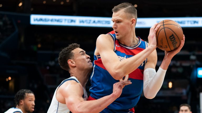 Dallas Mavericks center Dwight Powell, left, guards Washington Wizards center Kristaps Porzingis during the first half of an NBA basketball game Friday, April 1, 2022, in Washington. (Alex Brandon/AP)