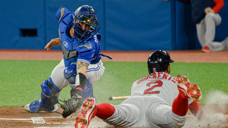 Boston Red Sox shortstop Xander Bogaerts (2) slides into home base to score during first inning MLB baseball action against the Toronto Blue Jays. (Christopher Katsarov/CP)