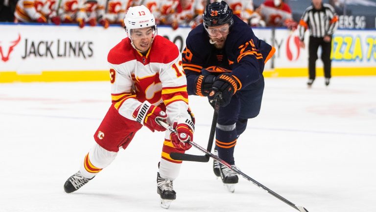 Edmonton Oilers' Leon Draisaitl (29) chases Calgary Flames' Johnny Gaudreau (13) during third period NHL action in Edmonton on Saturday, May 1, 2021. (Jason Franson/THE CANADIAN PRESS)