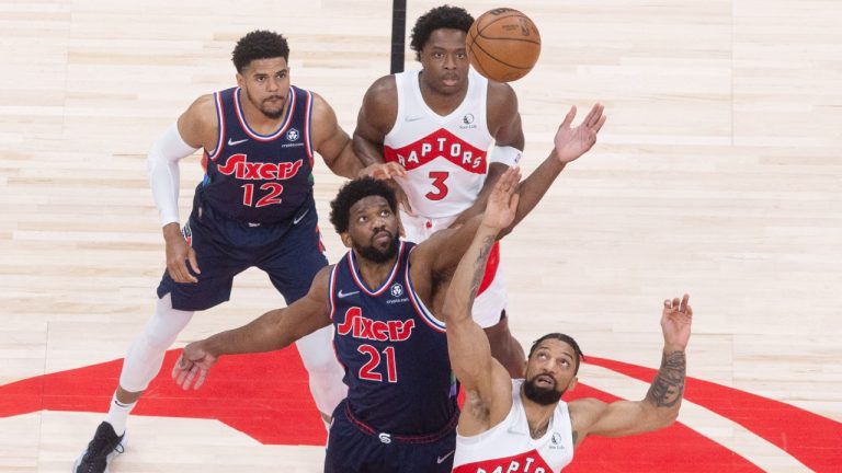 Philadelphia 76ers centre Joel Embiid (21) and Toronto Raptors centre Khem Birch (24) compete for the trip off during first half NBA first round playoff action in Toronto on Wednesday, April 20, 2022. (Chris Young/CP)