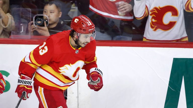 Calgary Flames left wing Johnny Gaudreau (13) celebrates his 100th season point, an assist, during third period NHL hockey action against the Seattle Kraken. (Larry MacDougal/CP)