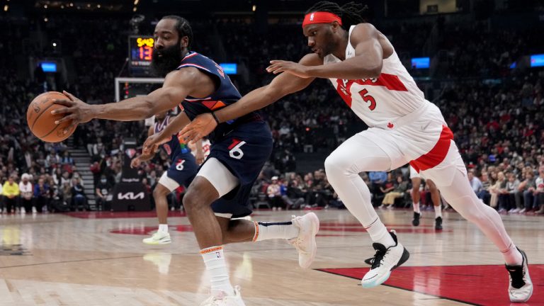 Philadelphia 76ers guard James Harden (1) and Toronto Raptors forward Precious Achiuwa (5) chase down a loose ball during first half NBA first round playoff action in Toronto, Saturday, April 23, 2022. (Nathan Denette/CP) 