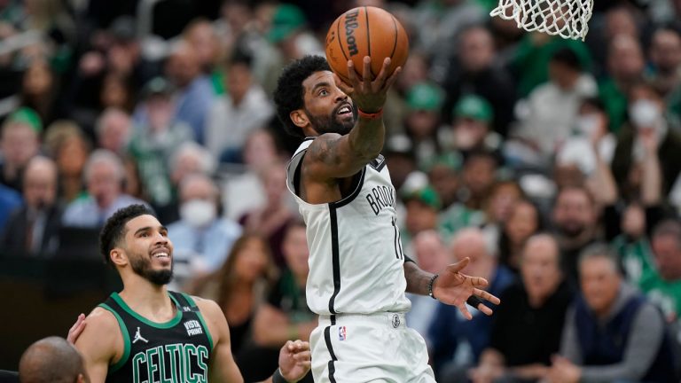 Brooklyn Nets guard Kyrie Irving (11) drives to the basket as Boston Celtics forward Jayson Tatum (0) looks on in the second half of Game 1 of an NBA basketball first-round Eastern Conference playoff series. (Steven Senne/AP)