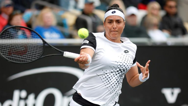 Ons Jabeur, of Tunisia, returns a shot to Amanda Anisimova, of the United States, during the semifinals at the Charleston Open tennis tournament in Charleston, S.C., Saturday, April 9, 2022. (Mic Smith/AP)