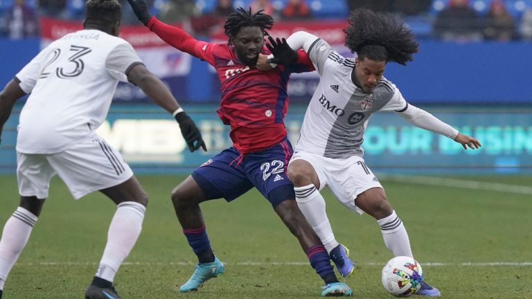 Toronto FC forward Jayden Nelson, far right, is taking on hunger at his former elementary school, while also taking on MLS defenders in his job as a professional soccer player. (LM Otero/AP)