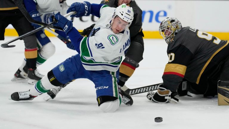 Vancouver Canucks left wing Juho Lammikko (91) attempts a shot on Vegas Golden Knights goaltender Robin Lehner (90) during the first period of an NHL hockey game Wednesday, April 6, 2022, in Las Vegas. (John Locher/AP)