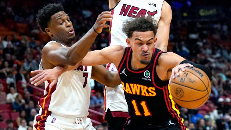 Atlanta Hawks guard Trae Young (11) tires to control the ball as Miami Heat guard Kyle Lowry (7) defends during the first half of an NBA basketball game. (Lynne Sladky/AP)