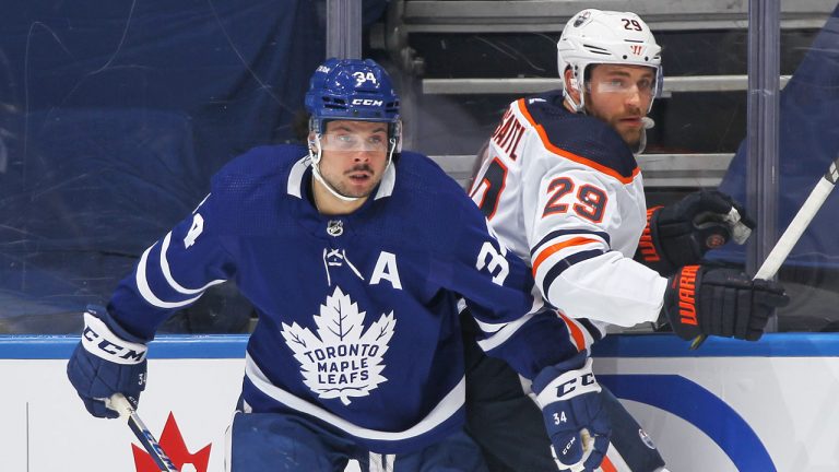 Leon Draisaitl of the Edmonton Oilers is bumped by Auston Matthews of the Toronto Maple Leafs. (Getty)