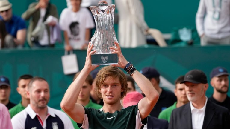 Andrey Rublev of Russia poses with trophy after winning the final tennis match of the Serbia Open tennis tournament against Novak Djokovic of Serbia, in Belgrade, Serbia, Sunday, April 24, 2022. (Darko Vojinovic/AP)