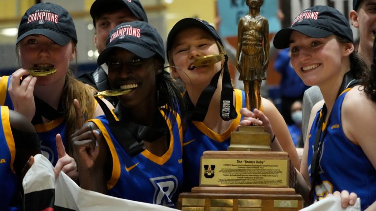 Ryerson Rams players celebrate after winning the gold medal at the U Sports women's university basketball championship in Kingston, Ont., Sunday, April. 3, 2022. The Ryerson Rams defeated the Winnipeg Wesmen to win the national championship. (Adrian Wyld/CP)