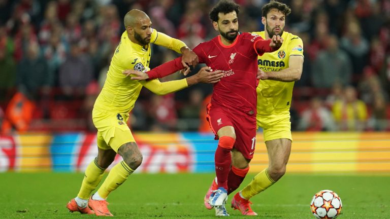 Liverpool's Mohamed Salah, center, fights for the ball with Villarreal's Etienne Capoue, left, Villarreal's Alfonso Pedraza during the Champions League semi final, first leg soccer match between Liverpool and Villarreal at Anfield stadium in Liverpool, England, Wednesday, April 27, 2022. (Jon Super/AP) 