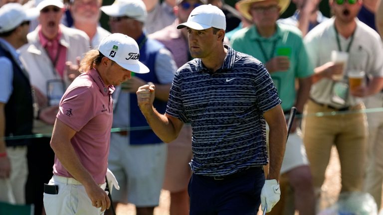 Scottie Scheffler pumps his fist as walks past Cameron Smith, of Australia, after a birdie chip on the third hole during the final round at the Masters golf tournament. (Robert F. Bukaty/AP)