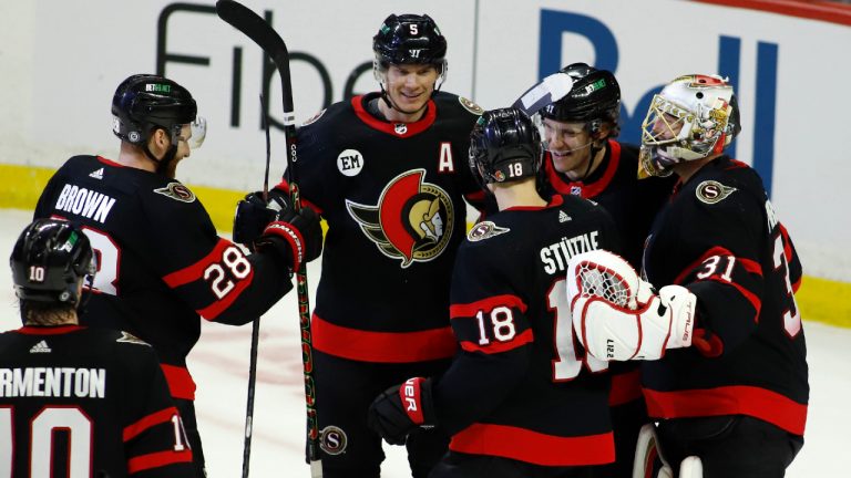 Ottawa Senators' Alex Formenton (10), Connor Brown (28), Nick Holden (5), Tim Stutzle (18), Nikita Zaitsev (22), and goaltender Anton Forsberg (31) celebrate after scoring an empty net goal during third period NHL hockey action against the Detroit Red Wings in Ottawa on Sunday, April 3, 2022. (Patrick Doyle/CP) 