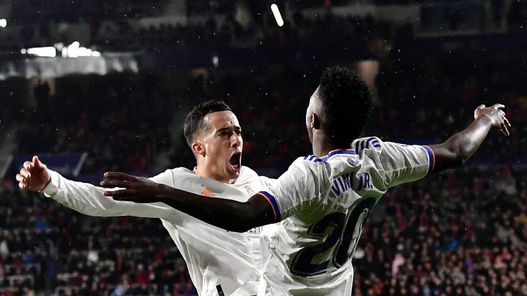 Real Madrid's Lucas Vazquez, left, celebrates with Real Madrid's Vinicius Junior after scoring his side's third goal during a Spanish La Liga soccer match between Osasuna and Real Madrid at El Sadar stadium in Pamplona, Spain, Wednesday, April 20, 2022. (Alvaro Barrientos/AP)