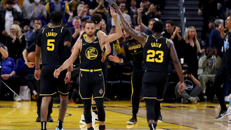 Golden State Warriors guard Stephen Curry (30) is congratulated by Draymond Green (23) during a timeout in the first half of Game 5 of the team's NBA basketball first-round playoff series against the Denver Nuggets. (Jed Jacobsohn/AP)