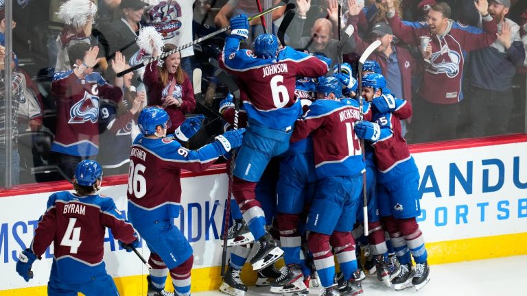 Colorado Avalanche defenceman Cale Makar is swarmed by teammates after scoring against the Nashville Predators during overtime in Game 2 of an NHL hockey Stanley Cup first-round playoff series Thursday, May 5, 2022, in Denver. The Avalanche won 2-1. (Jack Dempsey/AP Photo)