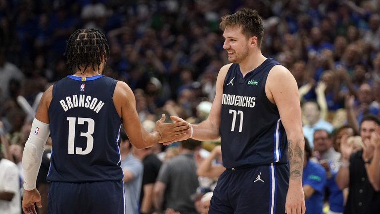 Dallas Mavericks' Jalen Brunson (13) and Luka Doncic (77) celebrate late in the second half of Game 4 of an NBA basketball second-round playoff series against the Phoenix Suns. (Tony Gutierrez/AP)