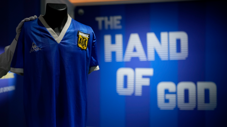 The Argentina football shirt worn by Diego Maradona in the 1986 Mexico World Cup quarterfinal soccer match between Argentina and England, is displayed for photographs at Sotheby's auction house, in London, Wednesday, April 20, 2022. (AP)