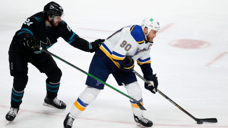 San Jose Sharks defenseman Jaycob Megna (24) checks St. Louis Blues center Ryan O'Reilly (90) during the third period of an NHL hockey game in San Jose, Calif., Thursday, April 21, 2022. (AP Photo/Josie Lepe)