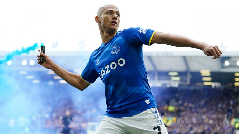 Everton's Richarlison tosses a flare as he celebrates after scoring his sides first goal during the Premier League soccer match between Everton and Chelsea at Goodison Park in Liverpool, England, Sunday, May 1, 2022. (Jon Super/AP)