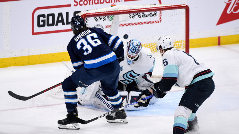 Winnipeg Jets' Morgan Barron (36) scores on Seattle Kraken goaltender Chris Driedger (60) during the first period of NHL action in Winnipeg on Sunday, May 1, 2022. (CP)