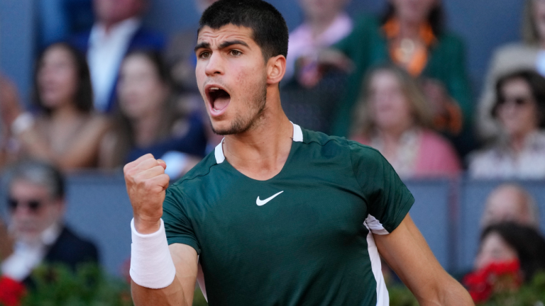 Carlos Alcaraz, of Spain, celebrates after winning a point during the final match with Alexander Zverev, of Germany, at the Mutua Madrid Open tennis tournament in Madrid, Spain, Sunday, May 8, 2022. (AP)