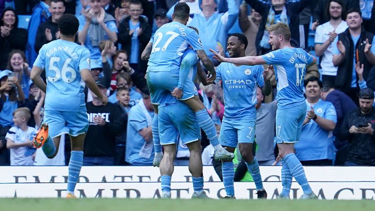 Manchester City's Raheem Sterling, second right, celebrates with teammates after scoring his side's fifth and his second goal during the English Premier League soccer match between Manchester City and Newcastle United at Etihad stadium in Manchester, England, Sunday, May 8, 2022. (Jon Super/AP)