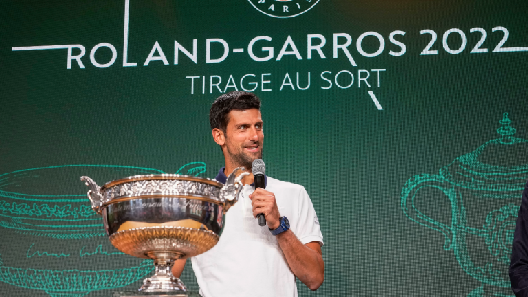 Defending champion Serbia's Novak Djokovic speaks next to the cup during the draw of the French Open tennis tournament at the Roland Garros stadium in Paris, Thursday, May 19, 2022. (AP)