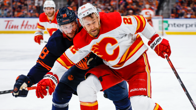 Calgary Flames forward Trevor Lewis, right, holds back Edmonton Oilers winger Zach Hyman during third period NHL second-round playoff hockey action in Edmonton, Tuesday, May 24, 2022. (CP)