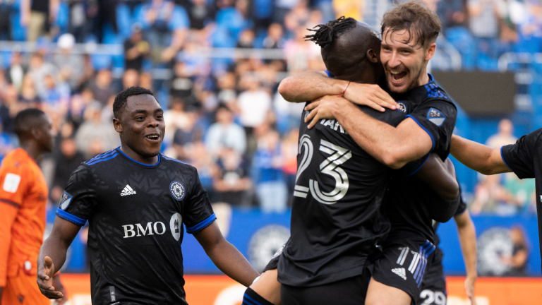 CF Montreal Matko Miljevic, right, celebrates with teammate Kei Kamara following a goal by forward Sunusi Ibrahim, left, as they face the Forge FC during first half Canadian Championship quarterfinal action in Montreal on Wednesday, May 25, 2022. (CP)