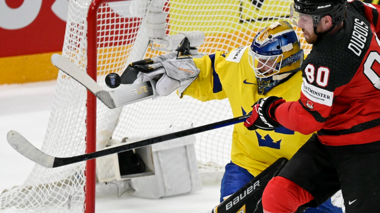 Goalkeeper Linus Ullmark of Sweden, left, and Pierre-Luc Dubois of Canada vie during the Hockey World Championship quarterfinal match between Sweden and Canada in Tampere, Finland, Thursday, May 26, 2022. (AP)