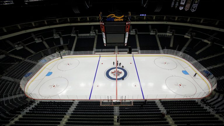 Winnipeg Jets staff lay down the Jet logo on Tuesday, January 8, 2013. THE CANADIAN PRESS/John Woods