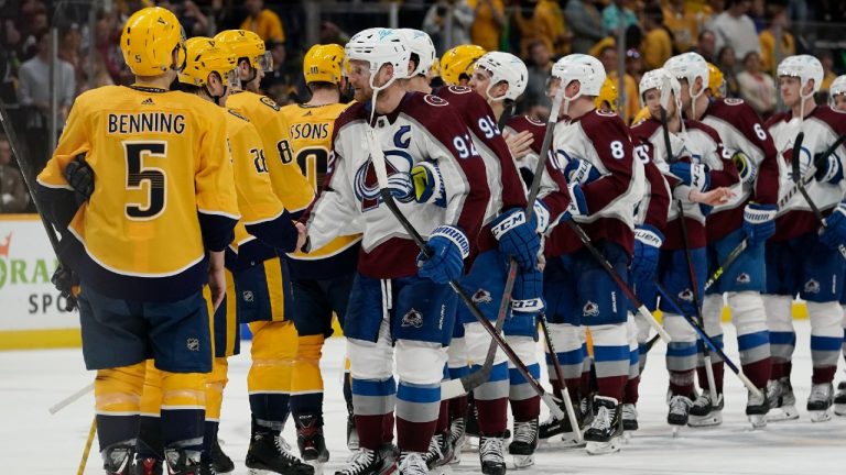 Colorado Avalanche left wing Gabriel Landeskog (92) leads the Avalanche as they shake hands with the Nashville Predators after Game 4 of an NHL hockey first-round playoff series Monday, May 9, 2022, in Nashville, Tenn. (Mark Humphrey/AP)