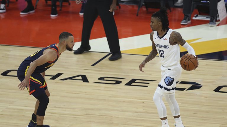 Memphis Grizzlies' Ja Morant, right, drives against Golden State Warriors' Stephen Curry during the first half of an NBA basketball Western Conference play-in game in San Francisco. (Jed Jacobsohn/AP)