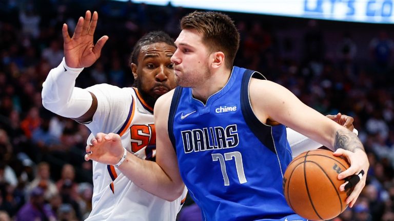 Dallas Mavericks guard Luka Doncic (77) battles Phoenix Suns forward Jae Crowder for space. (Brandon Wade/AP)