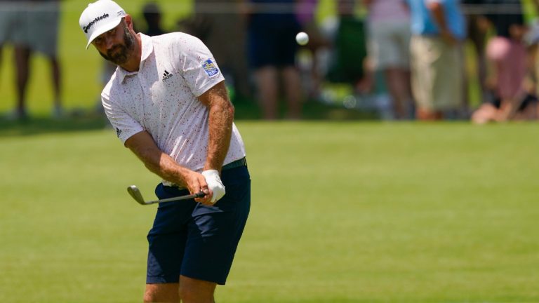 Dustin Johnson chips to the green on the first hole during a practice round for the PGA Championship golf tournament, Wednesday, May 18, 2022, in Tulsa, Okla. (Matt York/AP)