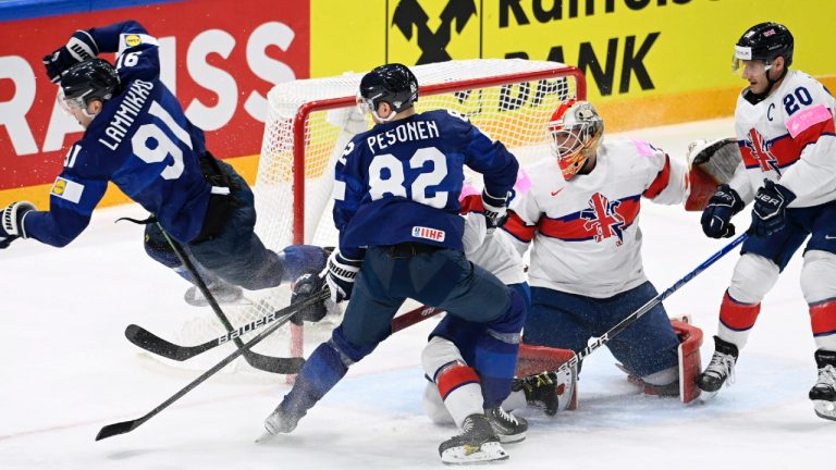 Finnish players Juho Lammikko, left, and Harri Pesonen take on Britain's goalkeeper Ben Bowns and Jonathan Phillips, right, during the group B Hockey World Championship match between Britain and Finland, in Tampere, Finland, Friday, May 20, 2022. (Heikki Saukkomaa/AP)