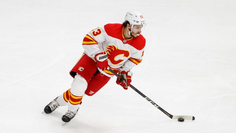 Calgary Flames left wing Johnny Gaudreau (13) looks to pass the puck against the Chicago Blackhawks during the first period of an NHL hockey game, Monday, April 18, 2022, in Chicago. (Kamil Krzaczynski/AP Photo)