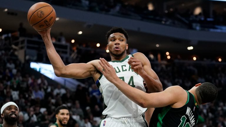 Milwaukee Bucks' Giannis Antetokounmpo rebounds in front o0f Boston Celtics' Grant Williams during the second half of Game 4 of an NBA basketball Eastern Conference semifinals playoff series Monday, May 9, 2022, in Milwaukee. The Celtics won 116-108 to tie the series 2-2. (Morry Gash/AP)