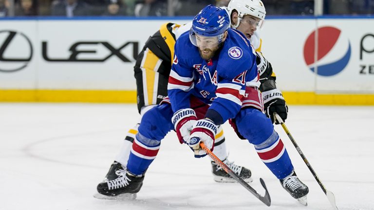 New York Rangers centre Barclay Goodrow (21) and Pittsburgh Penguins centre Evan Rodrigues (9) battle for the puck during the second period of an NHL hockey game.(John Minchillo/AP)