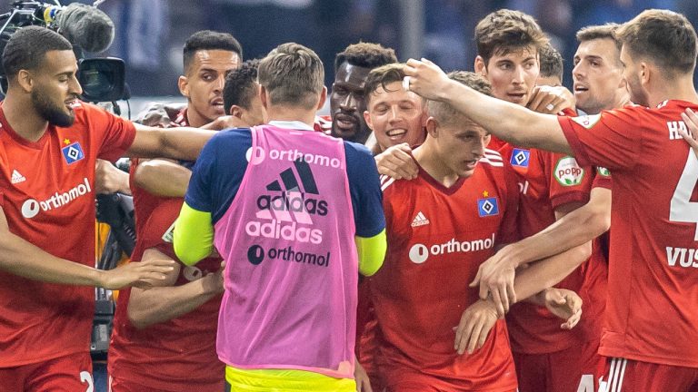 Ludovit Reis of Hamburger SV, second left, celebrates scoring with teammates during the Bundesliga relegation play off soccer match between Hertha BSC and Hamburger SV at Olympiastadion in Berlin, Thursday May 19, 2022. (Andreas Gora/dpa via AP)