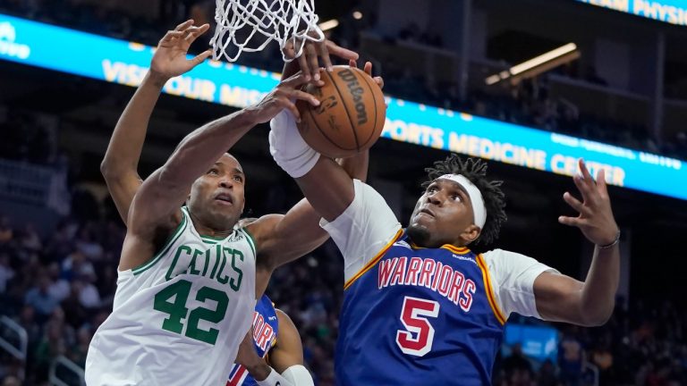 Boston Celtics center Al Horford (42) reaches for the ball next to Golden State Warriors center Kevon Looney (5) during the second half of an NBA basketball game in San Francisco, Wednesday, March 16, 2022. (Jeff Chiu/AP Photo)