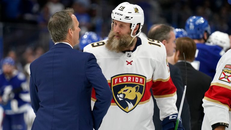 Florida Panthers centre Joe Thornton (19) congratulates Tampa Bay Lightning head coach Jon Cooper after the Lightning eliminated the Panthers during Game 4 of an NHL hockey second-round playoff series Monday, May 23, 2022, in Tampa, Fla. (Chris O'Meara/AP)